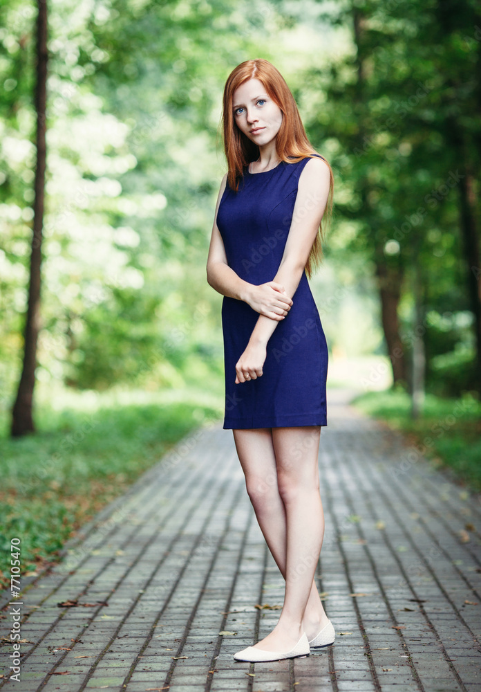 Calm cute redhead lady in a blue dress Stock Photo | Adobe Stock