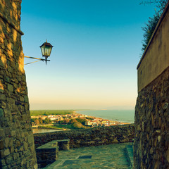 Wall Mural - Castiglione della Pescaia, lamp and terrace sunset view on the s