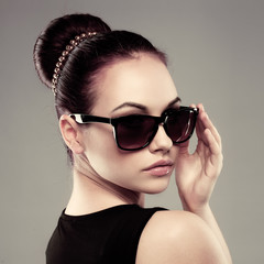 close-up of beautiful brunette model in stylish sunglasses