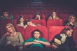 © Nejron Photo - Group of people watching boring movie in cinema