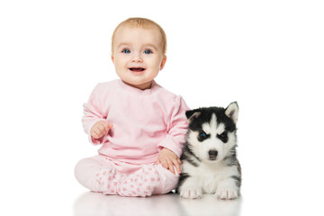 Wall Mural - Little girl with a puppy husky