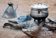 © okyela - Cooking corn cereal in contrule on fire in the village