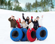 © Syda Productions - group of smiling friends with snow tubes