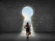 © ra2 studio - Business woman looking at keyhole with bright cityscape concept
