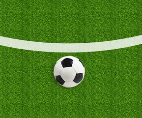 Soccer ball on green field grass