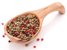 Black, Green And Pink Pepper Peppercorn Mix In Wooden Spoon Isol