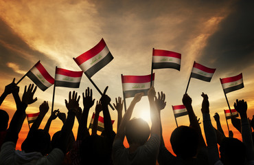 Wall Mural - Silhouettes People Waving Flag Iraq Concept