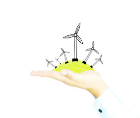 wind generator on green world by hand