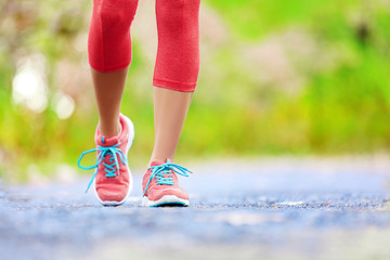 Wall Mural - Jogging woman with athletic legs and running shoes