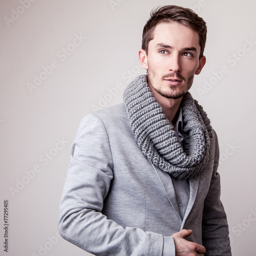 Fototapeta na wymiar Elegant young handsome man in grey costume. 