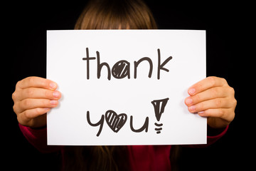 Child holding Thank You sign