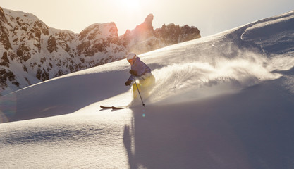 Poster - Male skier on downhill freeride with sun and mountain view