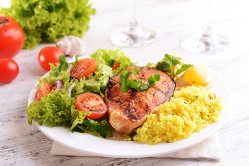 Poster - Tasty baked fish with rice on plate on table close-up