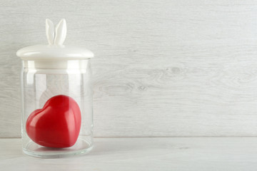 Wall Mural - Decorative heart in glass jar on light background