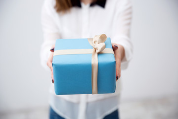 Sticker - Closeup portrait of female hands holding gift