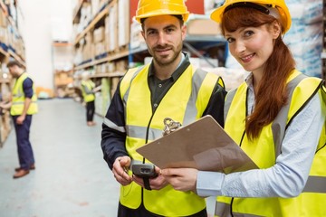 Warehouse team working together with clipboard