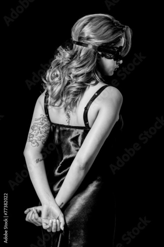 blindfold-woman-with-hands-behind-her-back-black-and-white-stock-photo