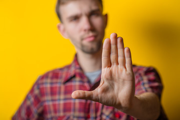 Young businessman doing a stop sign with his hand