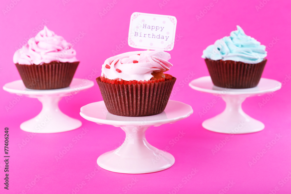 Delicious cupcakes with inscription on color background