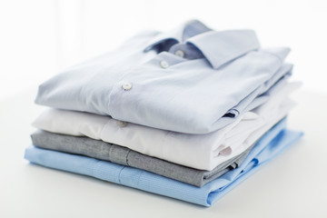 close up of ironed and folded shirts on table