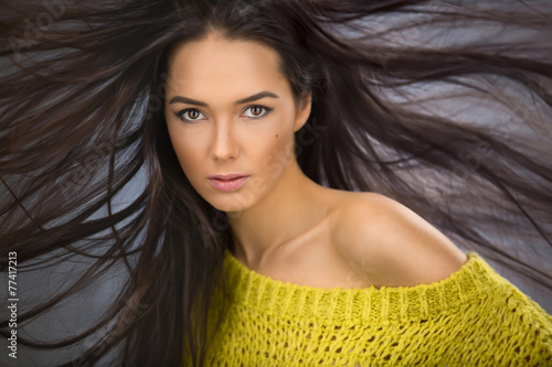 Naklejka na szybę Portrait of a charming sexy brunette with long flowing hair wind