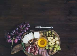 Wall Mural - Wine appetizers set: meat and cheese selection, honey, grapes