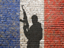 Shadow Of Man On France Flag Painted Brick Wall