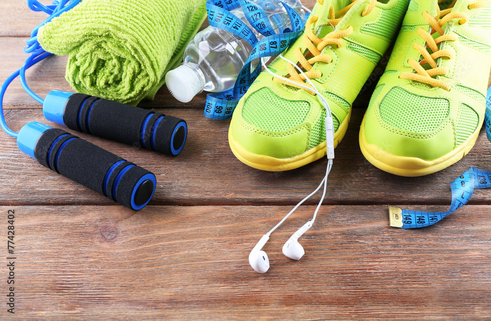 Different tools for sport on wooden background