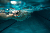Fototapeta Tęcza - Male swimmer at the swimming pool.Underwater photo.
