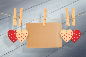 Poster - Composite image of hearts hanging on line with card