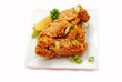Fried Chicken Served with Lemon and Green Scallions
