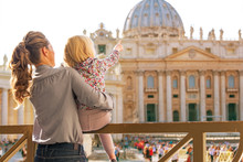 Mother And Baby Pointing On Basilica Di San Pietro In Vatican