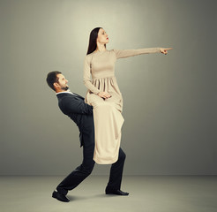 Wall Mural - young woman sitting on tired man