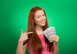 © pathdoc - woman showing holding money dollar bills on green background