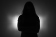 © Chris Tefme - Silhouette of young  girl with arms crossed