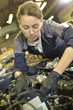 © goodluz - Technician woman working in auto repair workshop