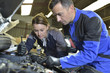 © goodluz - Mechanics instructor teaching woman in apprenticeship