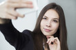 © sibkino - women taking selfie with mobile phone