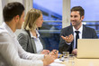 © ldprod - Three business peoples working together in meeting room