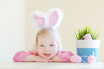 Wall Mural - Adorable toddler girl wearing bunny ears on Easter