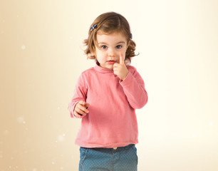 Little girl thinking over white background