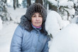 © Kekyalyaynen - Serene mature woman portrait in winter forest