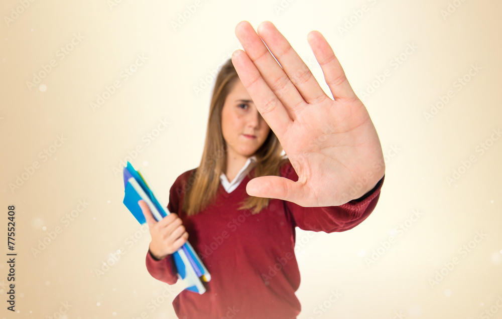 Student making stop sign over white background Stock Photo | Adobe Stock