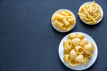 Wall Mural - Various types of pasta on the dark background