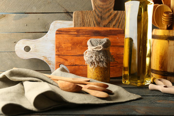 Wall Mural - Wooden kitchen utensils with glass bottle of olive oil