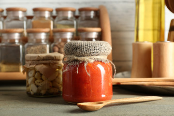 Wall Mural - Different spices canned vegetables in glass bottles