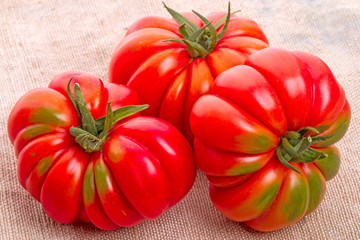 Wall Mural - Three tomatoes on burlap