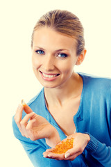 Wall Mural - Portrait of young smiling woman with Omega 3 fish oil capsules