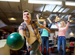 © Syda Productions - happy young man throwing ball in bowling club