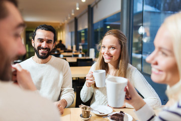 Wall Mural - happy friends meeting and drinking tea or coffee